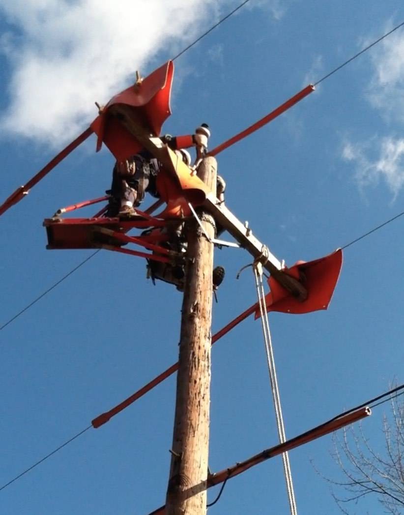 Lineman working aloft on a structure