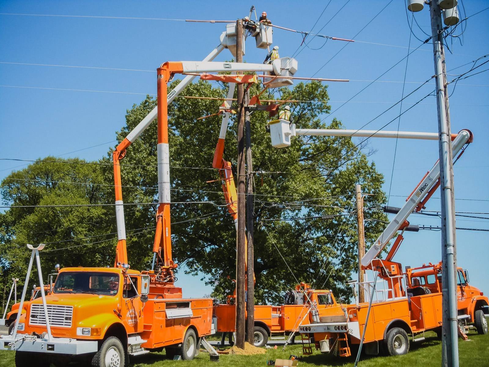 Two E&H bucket trucks working a distribution pole